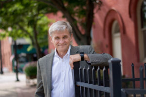 Robert Bob Fiala Portrait against fence